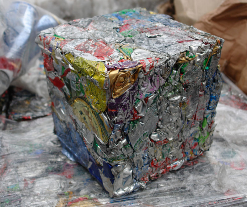 Photo of extruded aluminum waste in the form of a cube with a local focus
